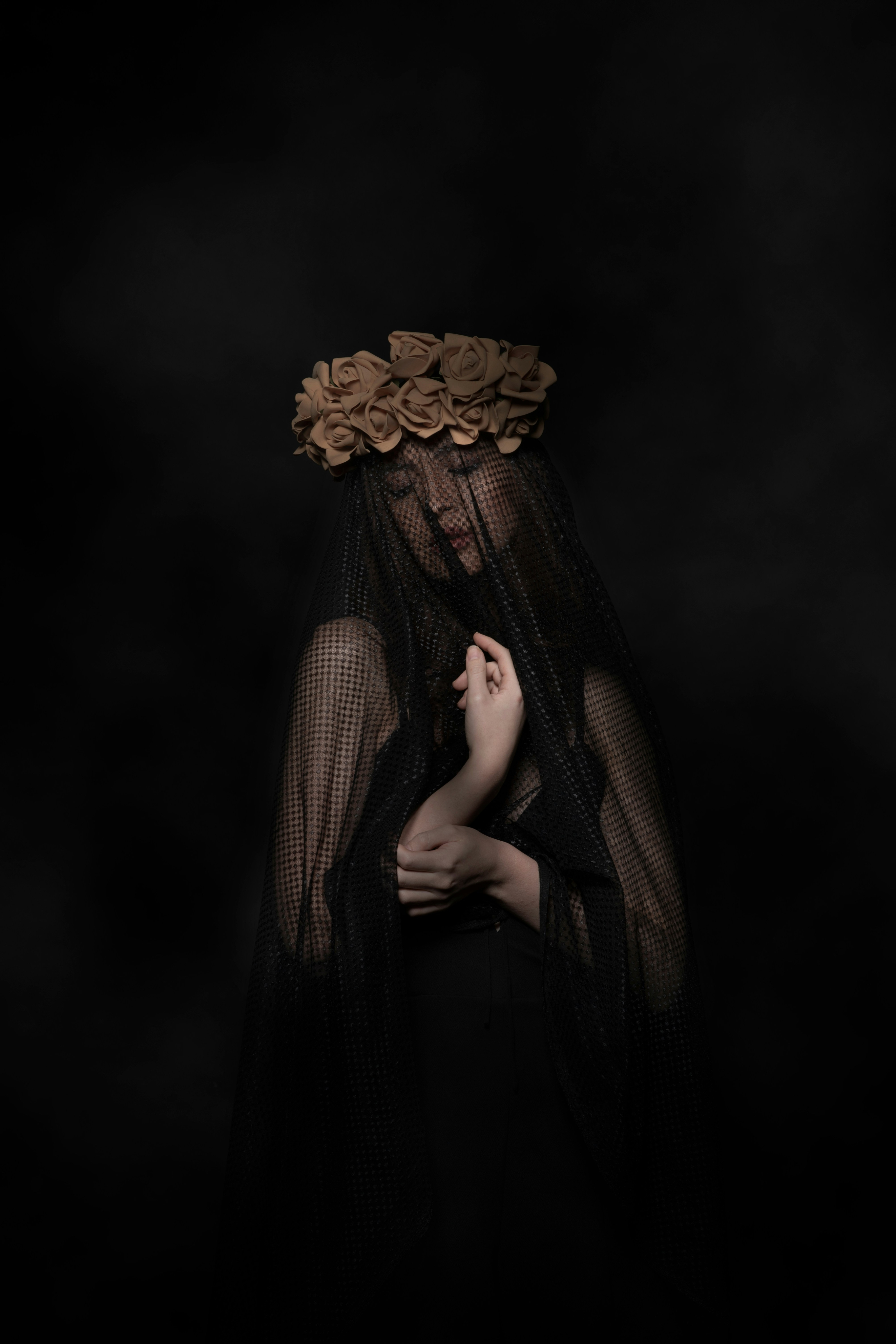 Side profile portrait under a dark veil 